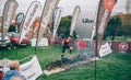 Runner jumping over burning logs in a test of extreme obstacle race