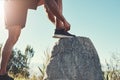 Runner, legs and tying laces on rock, outdoors and prepare for cardio and marathon training. Man, stone and shoes for Royalty Free Stock Photo