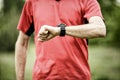 Runner looking at sport or smart watch checking pulse or gps Royalty Free Stock Photo