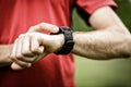 Runner looking at sport watch