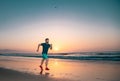 Runner man on the beach be running for exercise. Active healthy runner jogging outdoor. Young man training on the beach Royalty Free Stock Photo