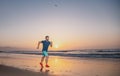 Runner man on the beach be running for exercise. Active healthy runner jogging outdoor. Young man training on the beach