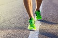 Runner man feet running on road closeup on shoe.