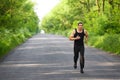 Runner man running on road training sprint. Sporting male run working out outside Royalty Free Stock Photo