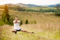 Runner man stretching legs before cross country trail run. Fit male runner exercise training outdoors in mountain Royalty Free Stock Photo