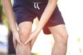 Runner man touching painful twisted or broken ankle. Athlete runner training accident. Royalty Free Stock Photo