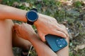 Runner on mountain forest trail checking looking at stopwatch smart watch Royalty Free Stock Photo