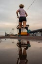 A runner passing a puddle while running at the beach