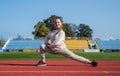 Runner prepare for race competition. sprinter warming up on stadium gym. flexibility. child training at school physical Royalty Free Stock Photo