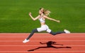 Runner. Professional sportswoman during running training session. Woman running jump on stadium track. Sportswoman in Royalty Free Stock Photo