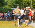 Runner racing in weighted vest with blurred background