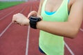 Runner ready to run set and looking at sports smart watch