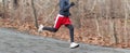 Runner running fast downhill in the woods with a blurred background Royalty Free Stock Photo