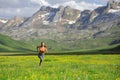 Runner running in a field in a high mountain