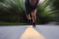 Runner running on the road, selective focus on shoes, with speed motion