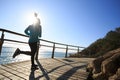 Runner running on seaside boardwalk during sunrise Royalty Free Stock Photo