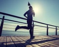 Runner running on seaside boardwalk during sunrise Royalty Free Stock Photo