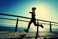 runner running on seaside boardwalk during sunrise Royalty Free Stock Photo