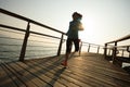 Runner running on seaside boardwalk during sunrise Royalty Free Stock Photo