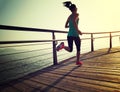 Runner running on seaside boardwalk during sunrise Royalty Free Stock Photo