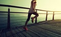 Runner running on seaside boardwalk during sunrise Royalty Free Stock Photo