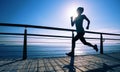 runner running on seaside boardwalk during sunrise Royalty Free Stock Photo