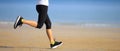 runner running on seaside sandy beach