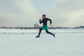 Runner running on snow and looking straight ahead Royalty Free Stock Photo