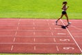 Runner on a running track finishing a race first Royalty Free Stock Photo