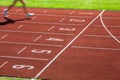 Runner on a running track finishing a race first Royalty Free Stock Photo