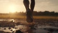 The runner runs in the mud at sunset, legs in sneakers close-up. AI generative