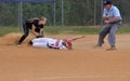 Runner slides into a base in a softball game