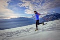 Runner on the snow with snowshoes downhill