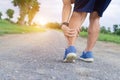 Runner sportsman holding leg in pain after suffering muscle injury during running workout training Royalty Free Stock Photo