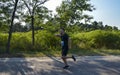 Runner with sportswear and running shoes during the marathon along the city streets Royalty Free Stock Photo