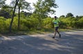 Runner with sportswear and running shoes during the marathon along the city streets Royalty Free Stock Photo