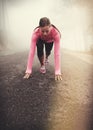 Runner, start and woman on path outdoor in forest, park or woods for exercise in winter. Morning, fog and person with Royalty Free Stock Photo