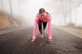 Runner, start and woman on path outdoor in forest, park or woods for exercise in winter. Morning, fog and person with Royalty Free Stock Photo