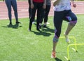 Runner stepping over mini hurdles in socks Royalty Free Stock Photo