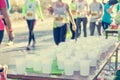 Runner taking a cup of water at H20 stand. Royalty Free Stock Photo