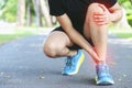 Runner touching painful twisted or broken ankle. Athlete runner training accident. Sport running ankle sprained sprain cause injur Royalty Free Stock Photo