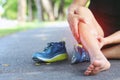 Runner touching painful twisted or broken ankle. Athlete runner training accident. Sport running ankle sprained sprain cause injur