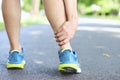 Runner touching painful twisted or broken ankle. Athlete runner training accident. Sport running ankle sprained sprain cause injur Royalty Free Stock Photo