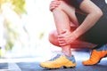 Runner touching painful twisted or broken ankle. Athlete runner training accident. Sport running ankle sprained sprain cause injur Royalty Free Stock Photo