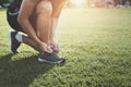 runner tying shoelace on grass at park Royalty Free Stock Photo