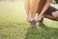 runner tying shoelace on grass at park Royalty Free Stock Photo