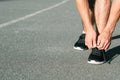 Runner tying shoelaces track field athletics sport