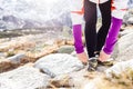 Runner tying sport shoe in mountains on trail Royalty Free Stock Photo