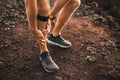 Runner using Knee support bandage with leg injury