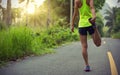 Runner warming up before running at morning forest trail Royalty Free Stock Photo